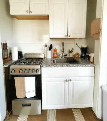 a kitchen with a stove and a sink at Chateau Blanc Yale Located Downtown in New Haven