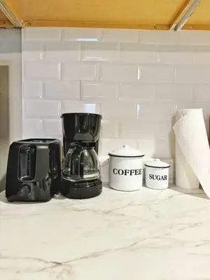 a coffee maker and two cups on a counter at Yale Casa Verde Studio in New Haven