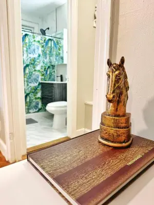 a statue of a lion on a table in a bathroom at Yale Casa Verde Studio in New Haven