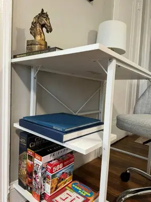 a white shelf with books and a horse on it at Yale Casa Verde Studio in New Haven
