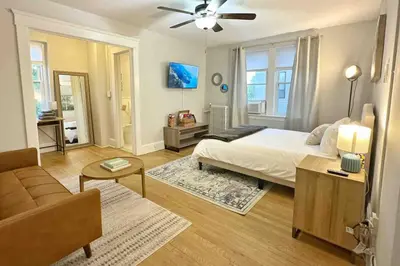 a bedroom with a bed and a living room at Yale Casa Azul Studio in New Haven