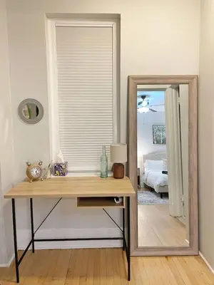 a dressing table with a mirror in a bedroom at Yale Casa Azul Studio in New Haven