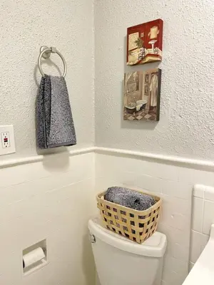 a bathroom with a basket on top of a toilet at Yale Casa Azul Studio in New Haven