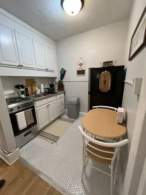a small kitchen with a table and a stove at Yale Casa Azul Studio in New Haven