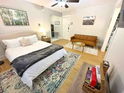 a bedroom with a bed and a living room with a couch at Yale Casa Azul Studio in New Haven