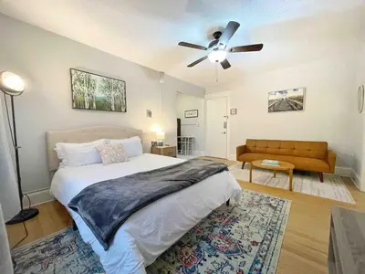 a bedroom with a bed and a ceiling fan at Yale Casa Azul Studio in New Haven