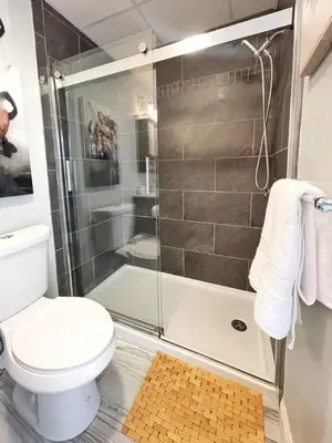 a bathroom with a shower and a toilet at Yale Modern Downtown Chateau in New Haven