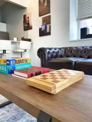 a chess board on a table in a living room at Yale Modern Downtown Chateau in New Haven