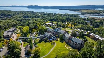 an aerial view of a campus with a lake at Windrose on Hudson in Ossining
