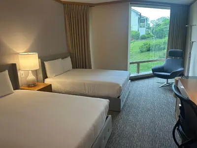 a hotel room with two beds and a window at Windrose on Hudson in Ossining