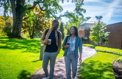a man and a woman walking down a sidewalk at Windrose on Hudson in Ossining