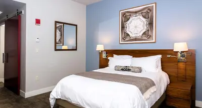 a bedroom with a large white bed with two lamps at Windrose on Hudson in Ossining