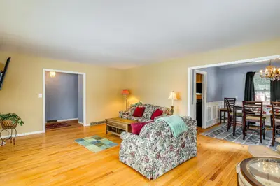 a living room with a couch and a table at 9 Mi to Lake George Village Home in Queensbury in Queensbury