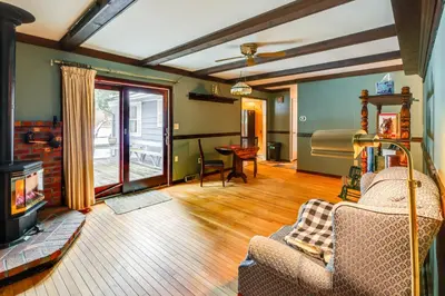 a living room with a couch and a fireplace at 9 Mi to Lake George Village Home in Queensbury in Queensbury