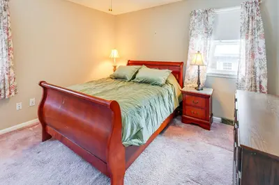 a bedroom with a bed and a dresser and a window at 9 Mi to Lake George Village Home in Queensbury in Queensbury