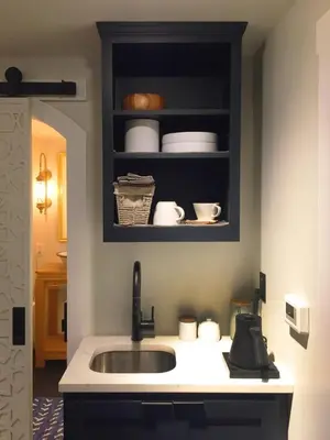 a kitchen with a sink and a shelf with dishes at JC Moroccan Hideaway in Jersey City