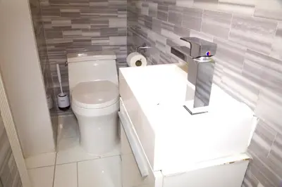 a bathroom with a white toilet and a sink at New2 York Style Stay near Central Park in New York