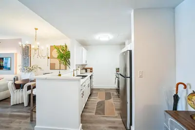 a kitchen with white cabinets and a kitchen island at The Gallery in Downtown Stamford in Stamford