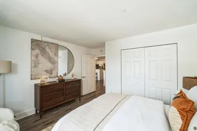 a bedroom with a large bed and a mirror at The Gallery in Downtown Stamford in Stamford