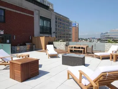 a patio with chairs and tables on top of a building at The Gallery in Downtown Stamford in Stamford