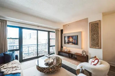 a living room with a view of a balcony at The Gallery in Downtown Stamford in Stamford