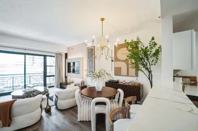 a dining room and living room with a dining table and chairs at The Gallery in Downtown Stamford in Stamford