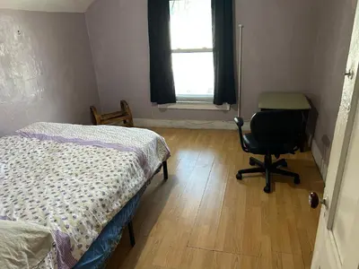 a bedroom with a bed and a desk and a chair at 1Br Studio At East Rock in New Haven