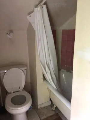 a bathroom with a toilet and a bath tub at 1Br Studio At East Rock in New Haven