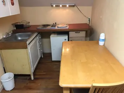 a small kitchen with a sink and a table at 1Br Studio At East Rock in New Haven