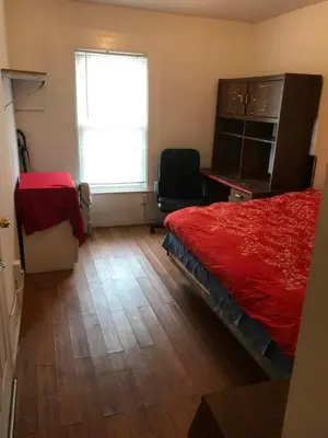 a bedroom with a red bed and a window at 1Br Studio Across From Yale New Haven Hospital in New Haven