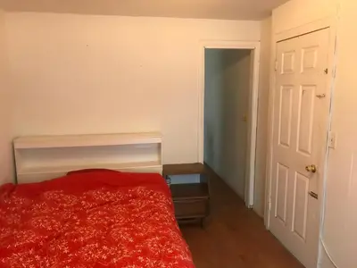 a bedroom with a bed with a red blanket at 1Br Studio Across From Yale New Haven Hospital in New Haven