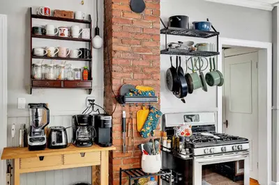 a kitchen with a stove and a brick wall at Spacious Home with Yard and Patio, 2 Mi to Dtwn Troy in Troy