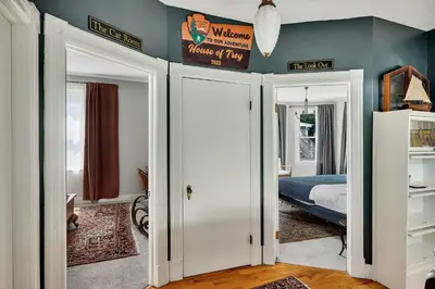 a bedroom with a bed and two open doors at Spacious Home with Yard and Patio, 2 Mi to Dtwn Troy in Troy