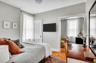 a bedroom with a bed and a desk and a television at Spacious Home with Yard and Patio, 2 Mi to Dtwn Troy in Troy