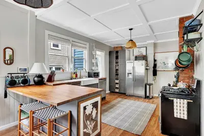 a kitchen with a counter and a refrigerator at Spacious Home with Yard and Patio, 2 Mi to Dtwn Troy in Troy