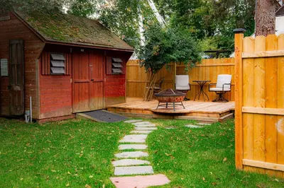 a backyard with a wooden fence and a patio at Spacious Home with Yard and Patio, 2 Mi to Dtwn Troy in Troy