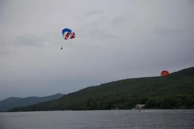 a person flying a kite over a body of water at Lake George Residence LLC in South Glens Falls