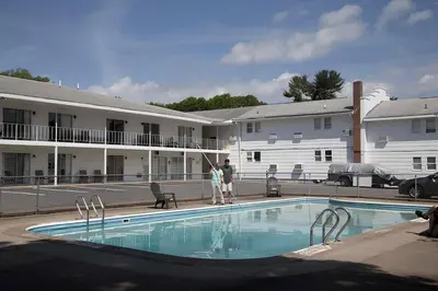a person is standing next to a swimming pool at Lake George Residence LLC in South Glens Falls