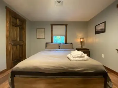 a bedroom with a large bed with two towels on it at STUNNING RENOVATED 4BR House in Southington