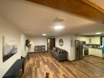 a living room with a couch and a kitchen at STUNNING RENOVATED 4BR House in Southington