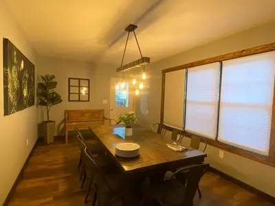 a dining room with a wooden table and chairs at STUNNING RENOVATED 4BR House in Southington