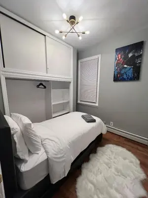 a bedroom with a bed and a ceiling fan at Waterfront 4BR apt - 15Min to MetLife and TIMES SQ in Union City