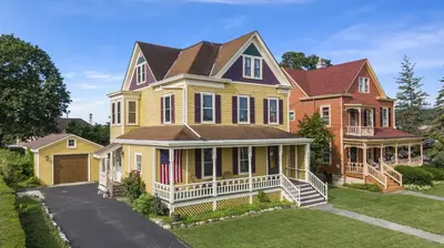 a large yellow house with an american flag on it at The Grandview, Catskill NY in Catskill