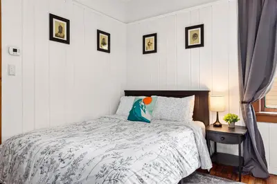 a bedroom with a bed and a table with a lamp at The Grandview, Catskill NY in Catskill