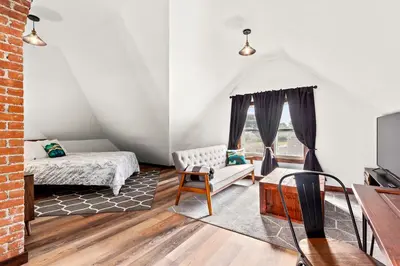 a living room with a bed and a couch at The Grandview, Catskill NY in Catskill