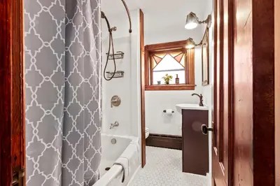a bathroom with a shower and a tub and a sink at The Grandview, Catskill NY in Catskill