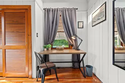 a table and chair in a room with a window at The Grandview, Catskill NY in Catskill