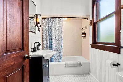 a bathroom with a sink and a tub and a toilet at The Grandview, Catskill NY in Catskill