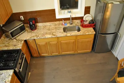 a kitchen with a sink and a stainless steel refrigerator at MOTEL House in Newark