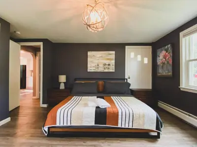 a bedroom with a bed and a chandelier at Centrally Located - 3 Br House in Southington